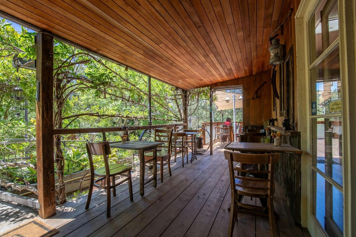 outdoor seating amongst green gardens and rustic decor