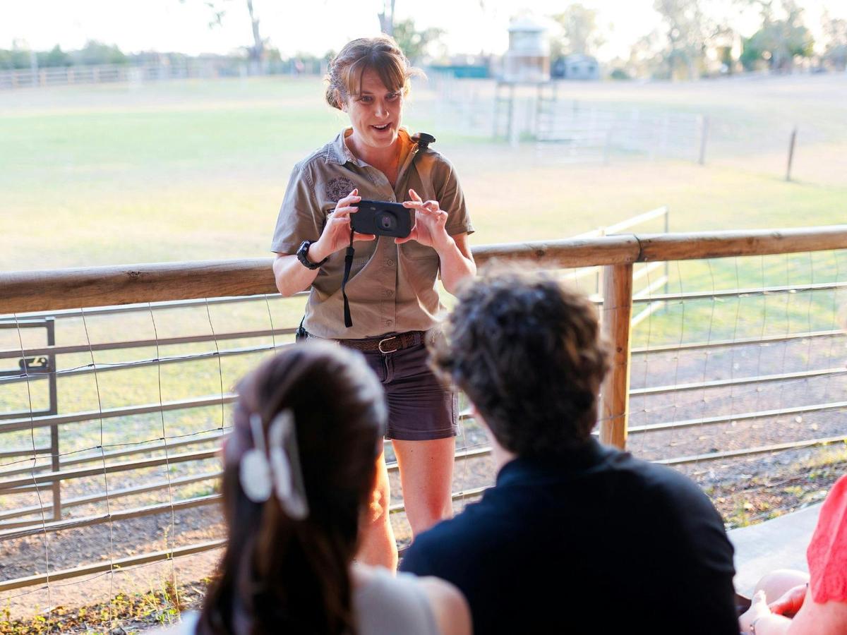 An education officer demonstrates how to use night vision equipment before a Nocturnal Night Tour be