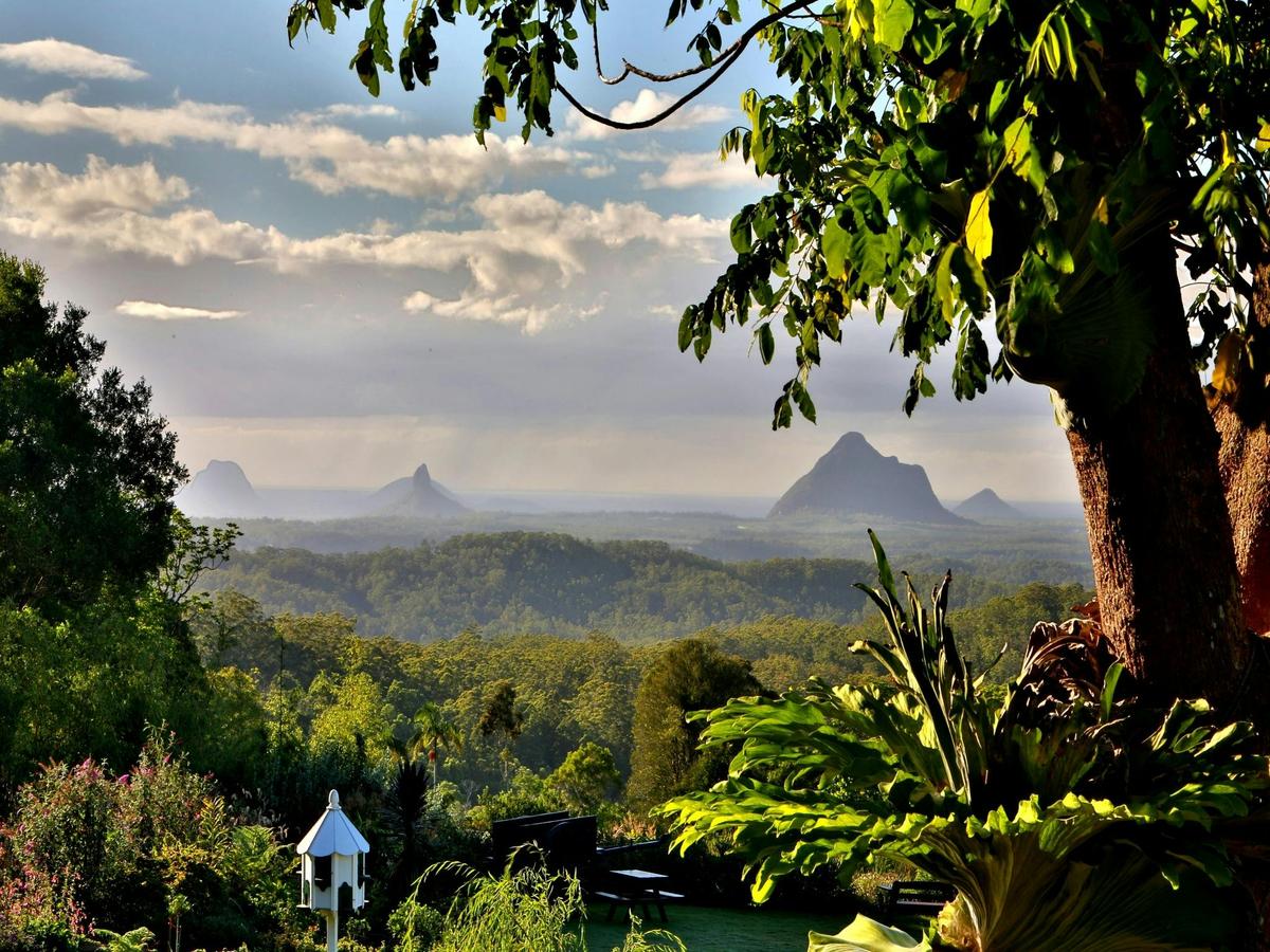 18 acres of gardens surrounded by stunning waterfalls & lakes overlooking the Glass House Mountains