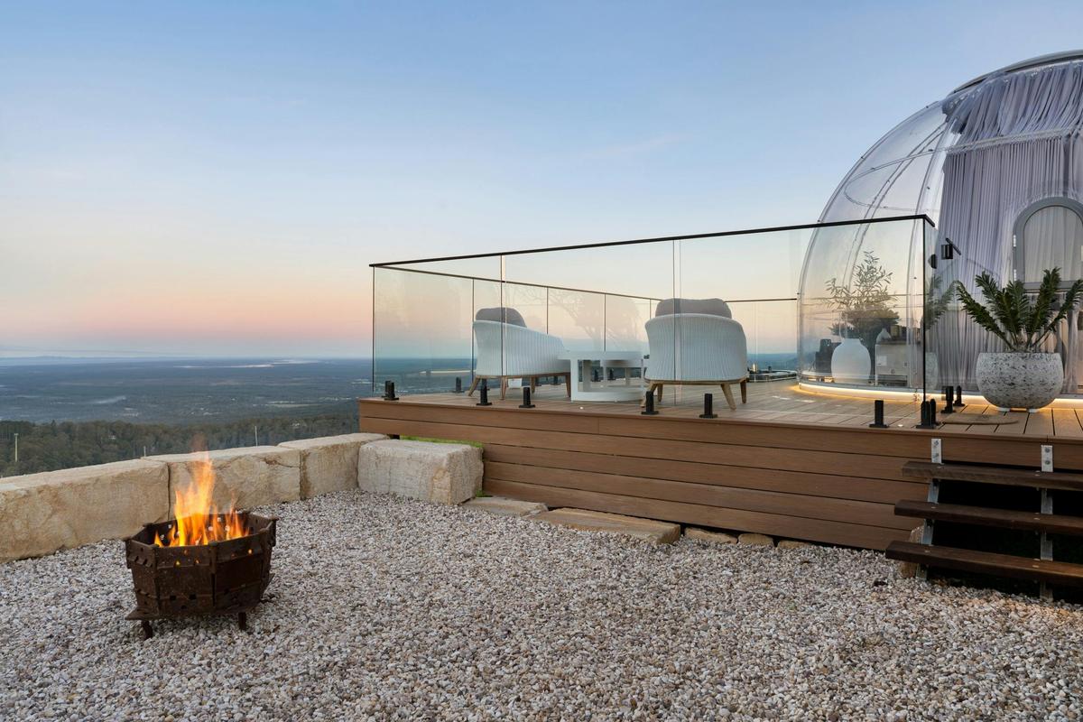 The Magical Dome outdoor area with a spa & firepit