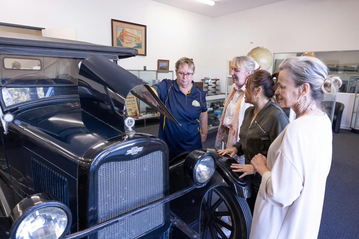 visitors viewing the 1926 chevrolet sedan