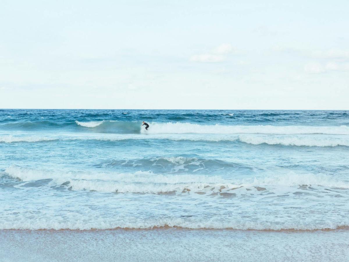 Surfer at Narrawallee Beach