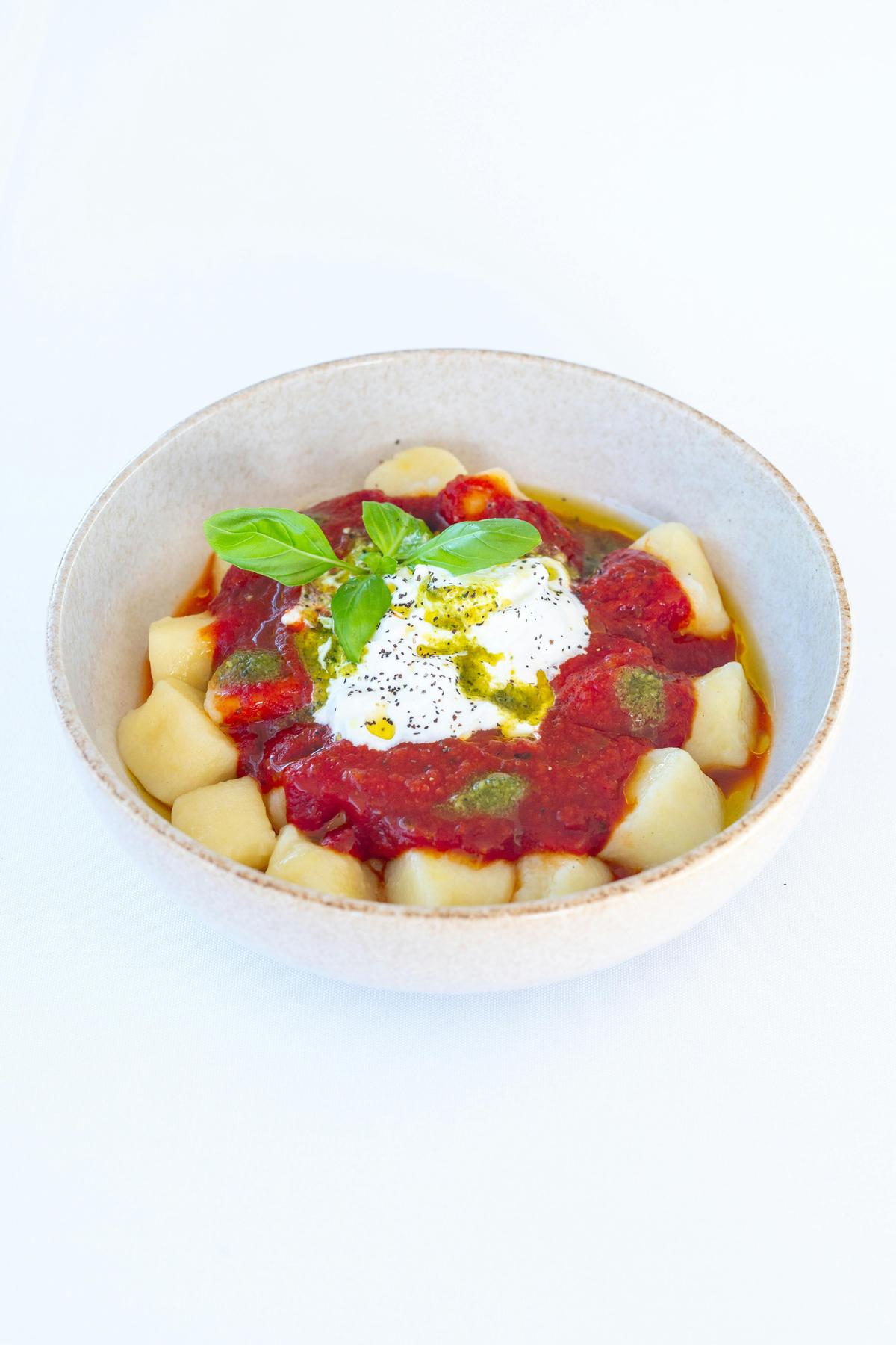 Homemade Soft Gnocchi Tossed in nonna’s Napoli sauce, served with creamy Stracciatella cheese