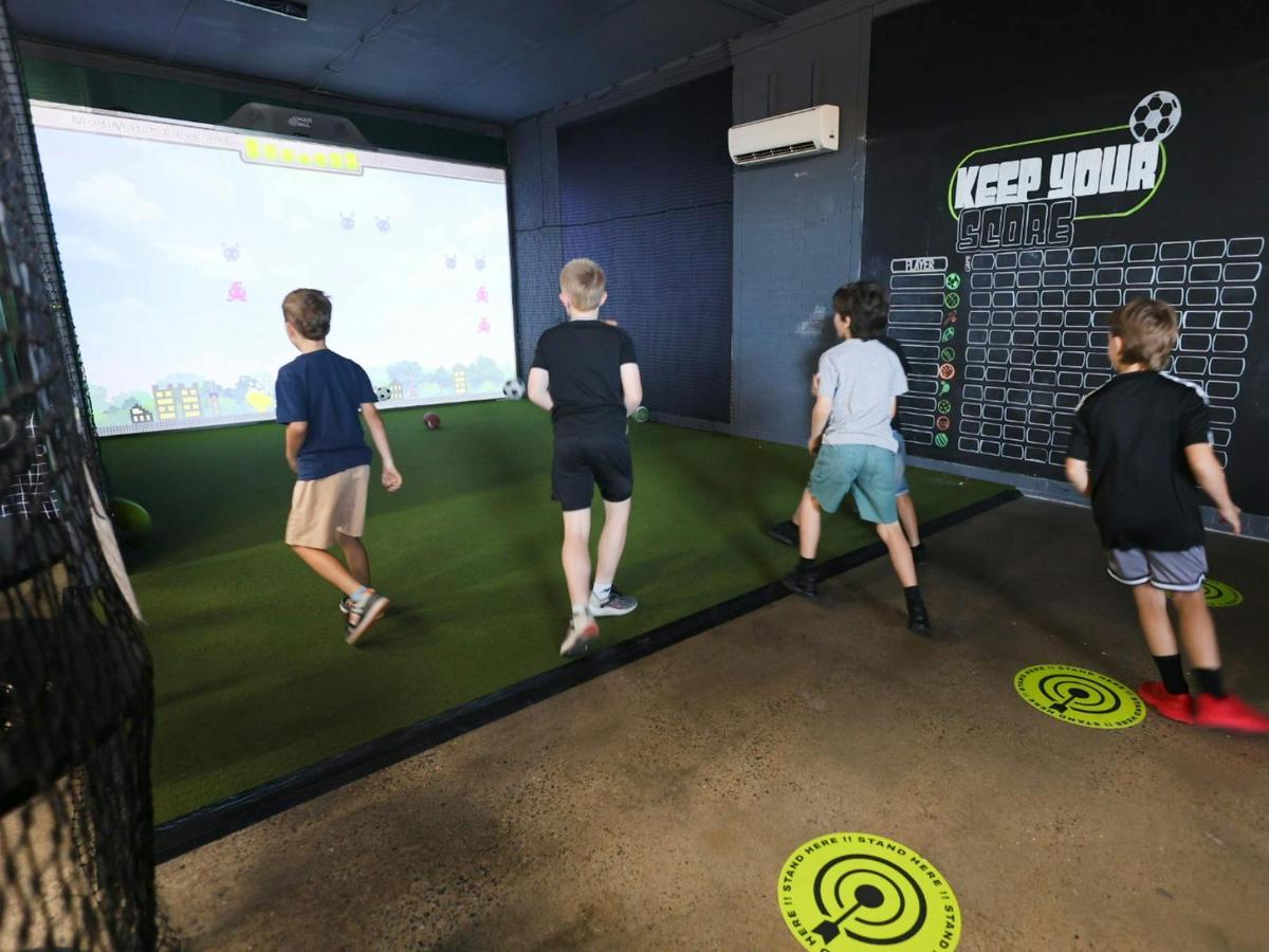 Group session at MultiMatch Cleveland playing interactive sports games indoors.