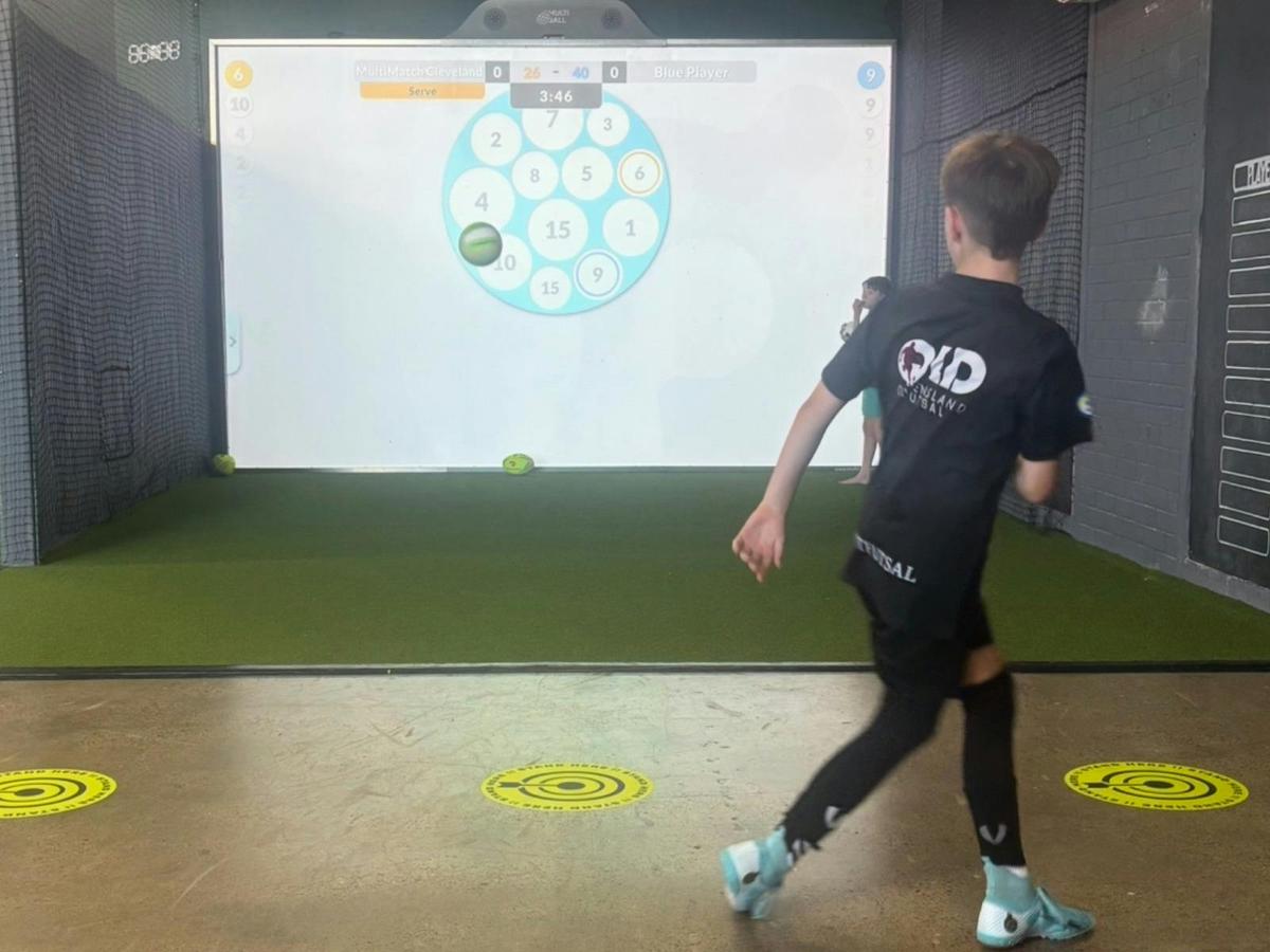 MultiMatch Cleveland soccer player testing skills challenge with a player aiming at indoor targets.