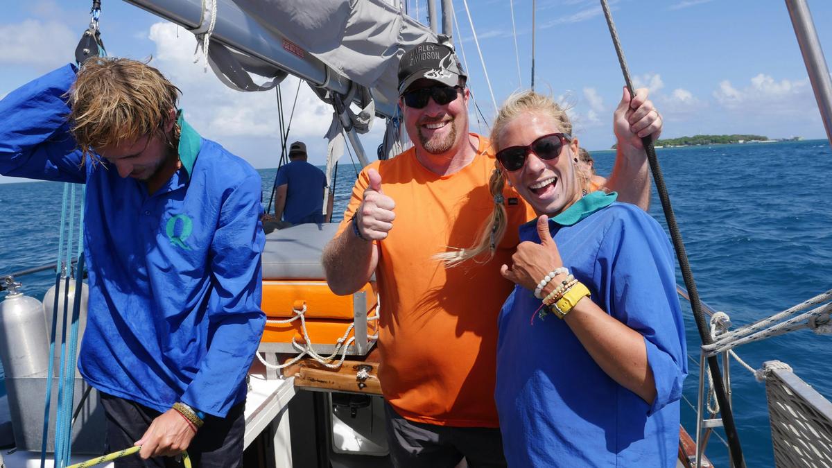 Guest assistance with hoisting sail on Ocean Free