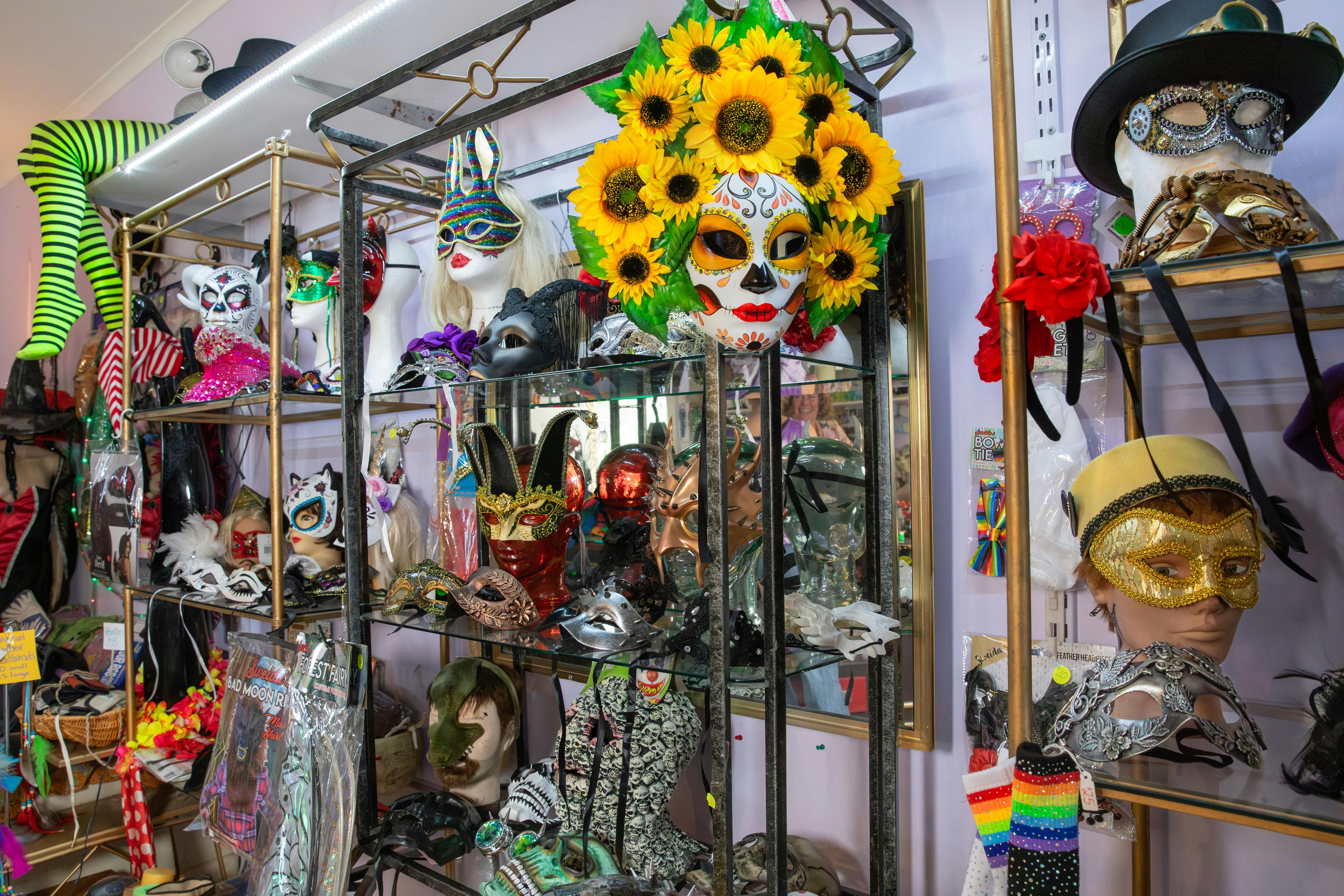 Wall displays featuring masks and party outfits