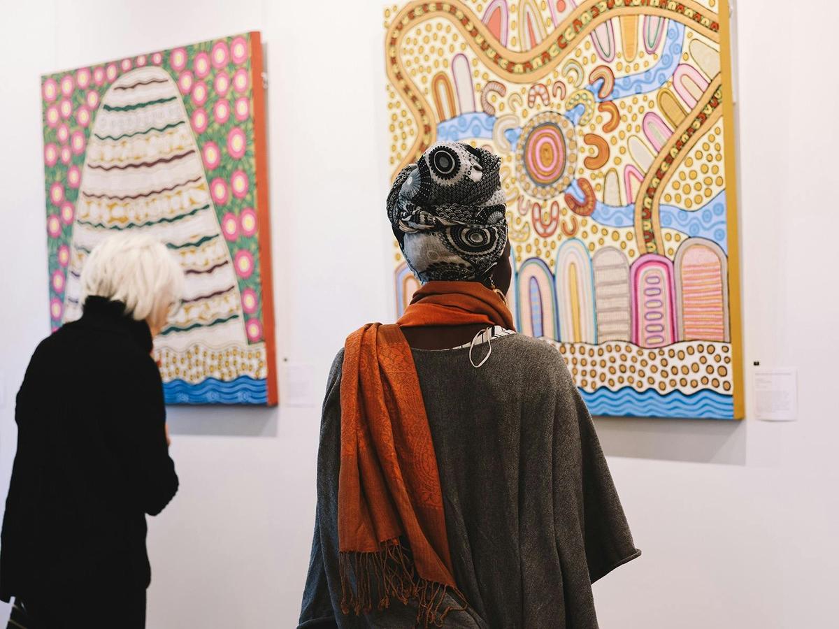 Audience looking at Enid Morris Midden paintings