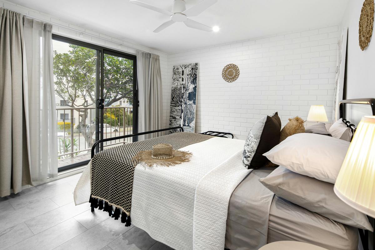 The main bedroom has aircon, fan, views, queen bed, and crisp clean bedding