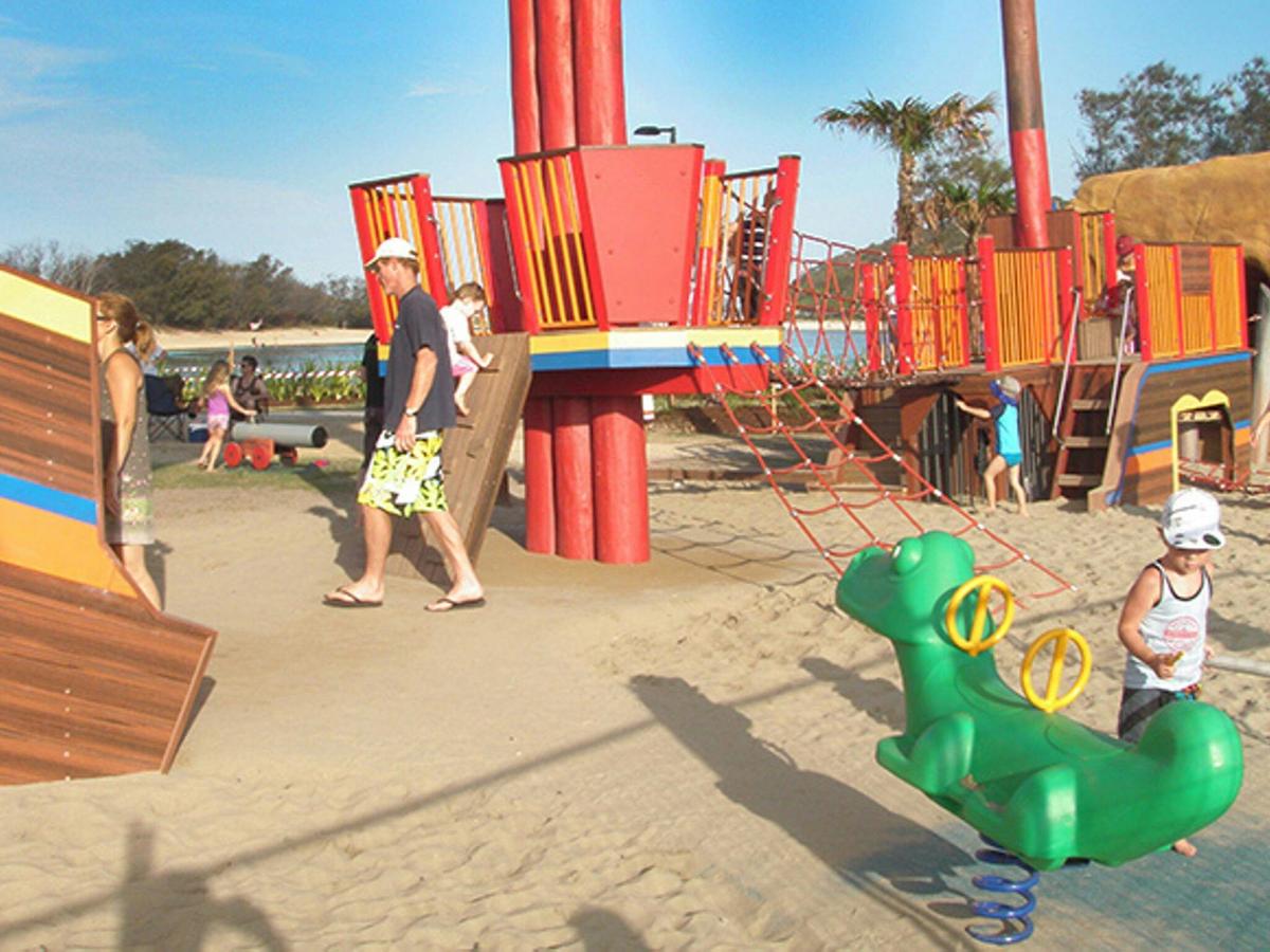 Children playing on gym equipment at the Palm Beach parklands