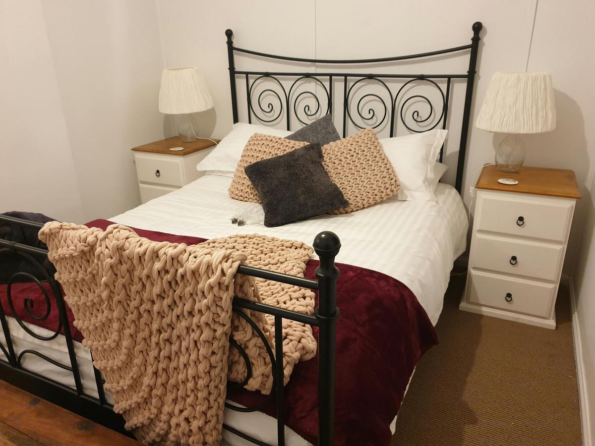 Brass framed bed with luxurious linens and soft blankets