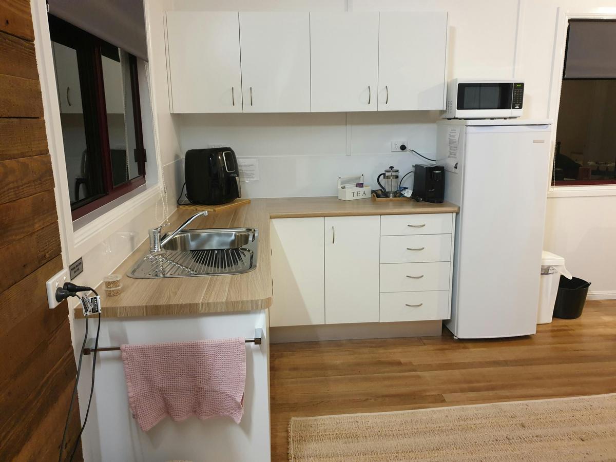Full kitchenette complete with fridge, air fryer, kettle, microwave and all cooking utensils
