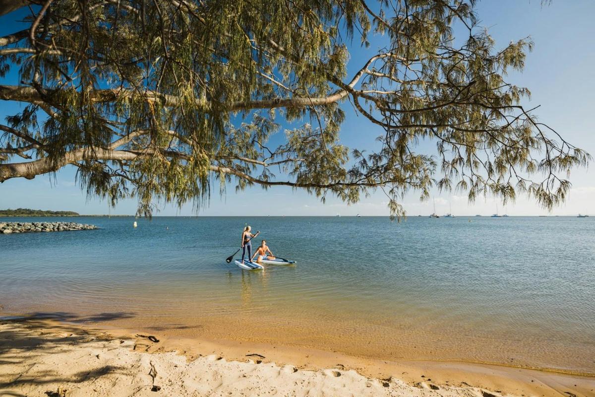 Couple Paddle Boarding at Raby Bay Foreshore Park, Redlands Coast