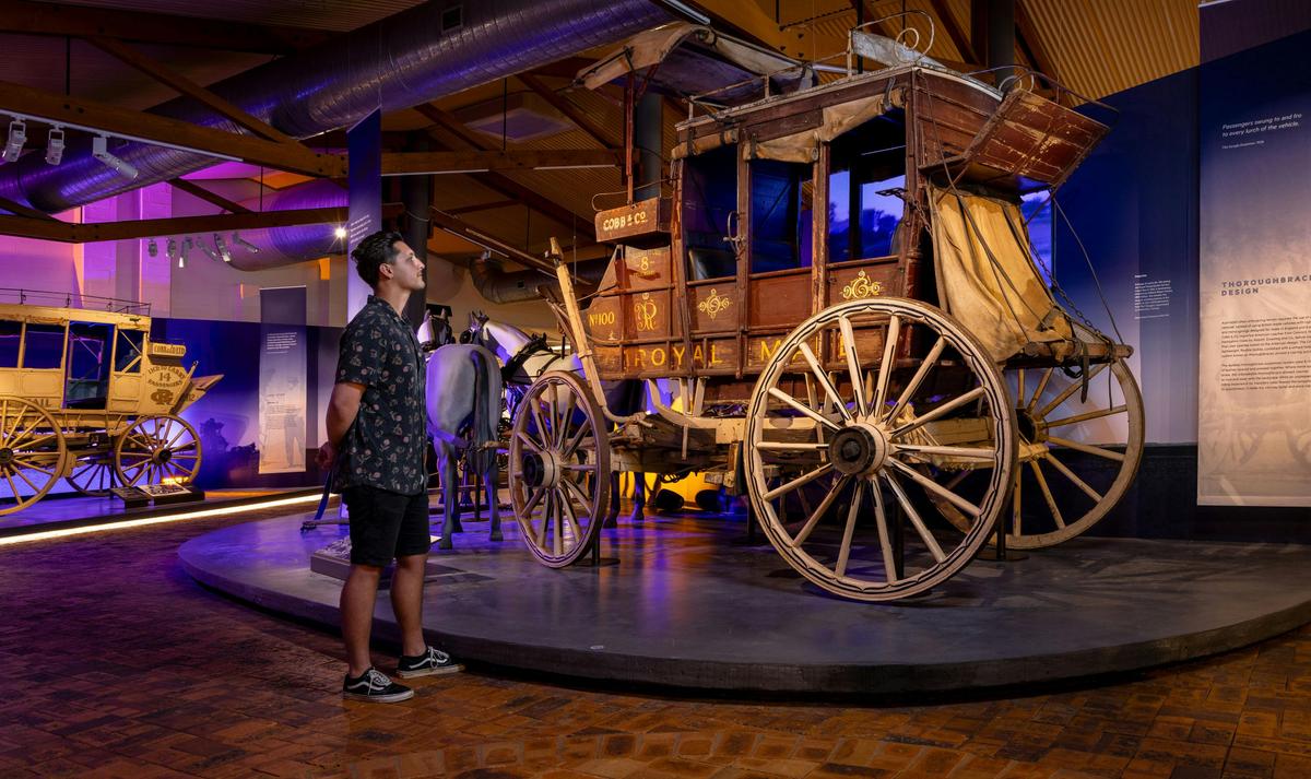 Man looking at coach in the National Carriage Collection