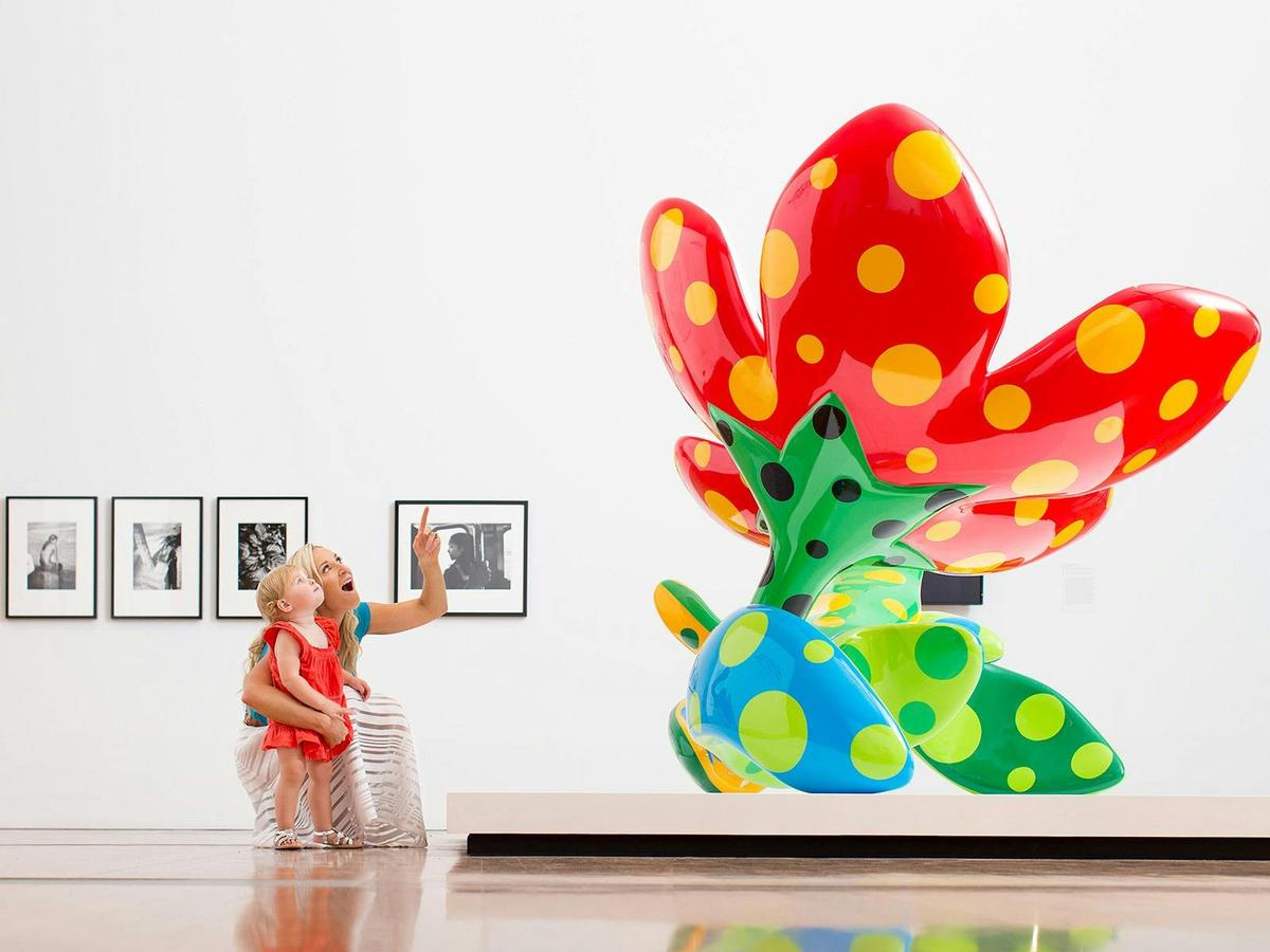 Visitors with Yayoi Kusama's 'Flowers that bloom at midnight' 2012 / GOMA2