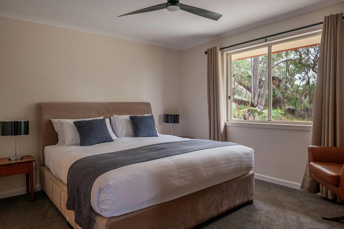 King bed in ensuited Bedroom 1 in Shiraz Cottage at Sancerre Estate in Ballandean, Queensland