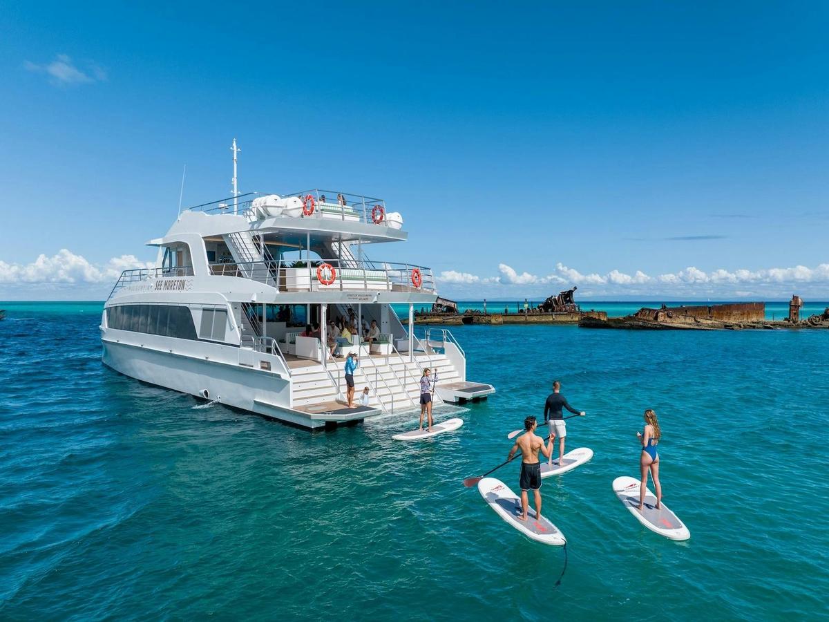 Stand up paddleboarding around the Tangalooma Wrecks with See Moreton