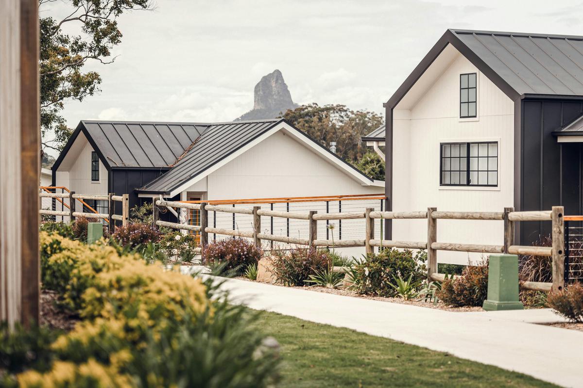 Pathway to cabins with Glasshouse Mountains in the background