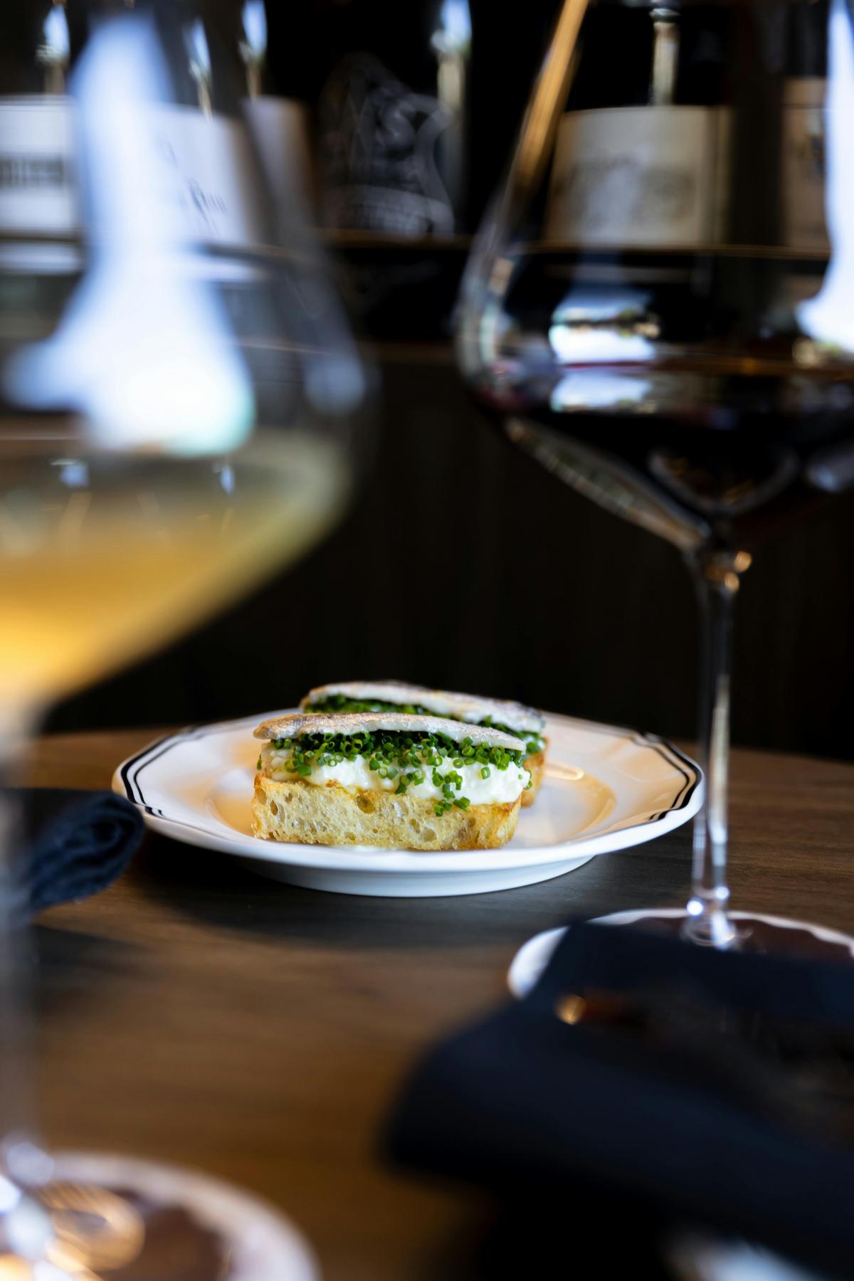 Anchovy Toast with a glass of French Red