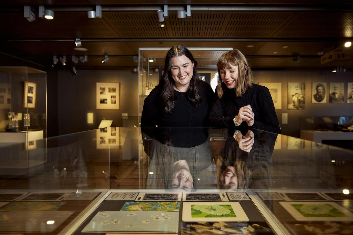 two females looking into a glass display