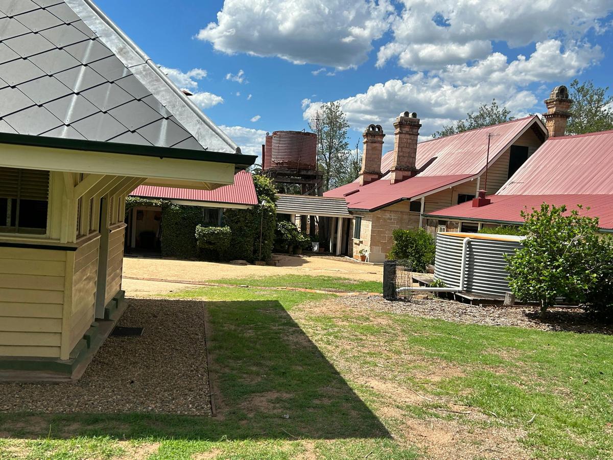 Homestead noting sandstone chimneys and wall