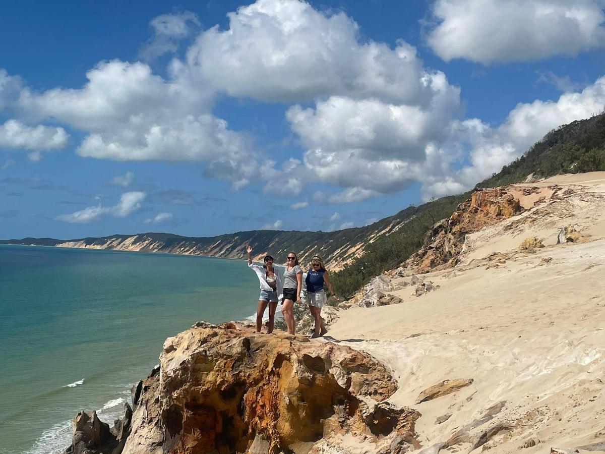 Sunny Jeeps - 3 girls at Carl Sand Blow Rainbow Beach standing on rocks