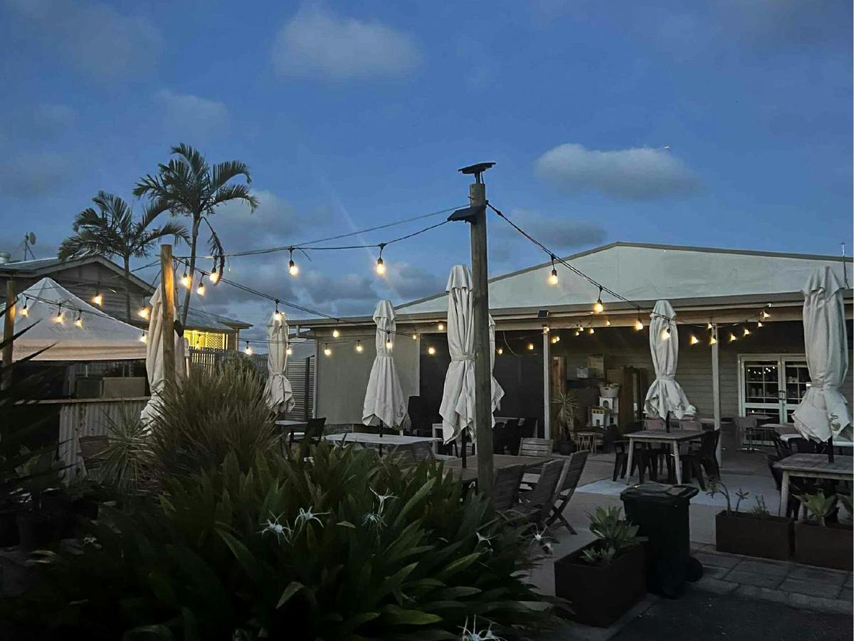 Festoon lighting at the outdoor dining area sets the mood for evenning events at the Grounds