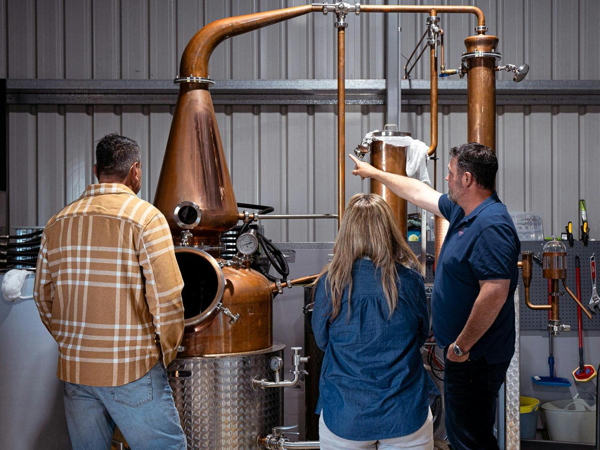 People looking at gin still