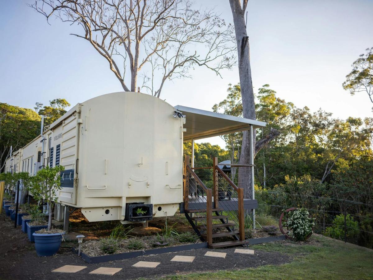 Stay in a charming train carriage at Hitching Rail Retreat—where history meets comfort in nature.