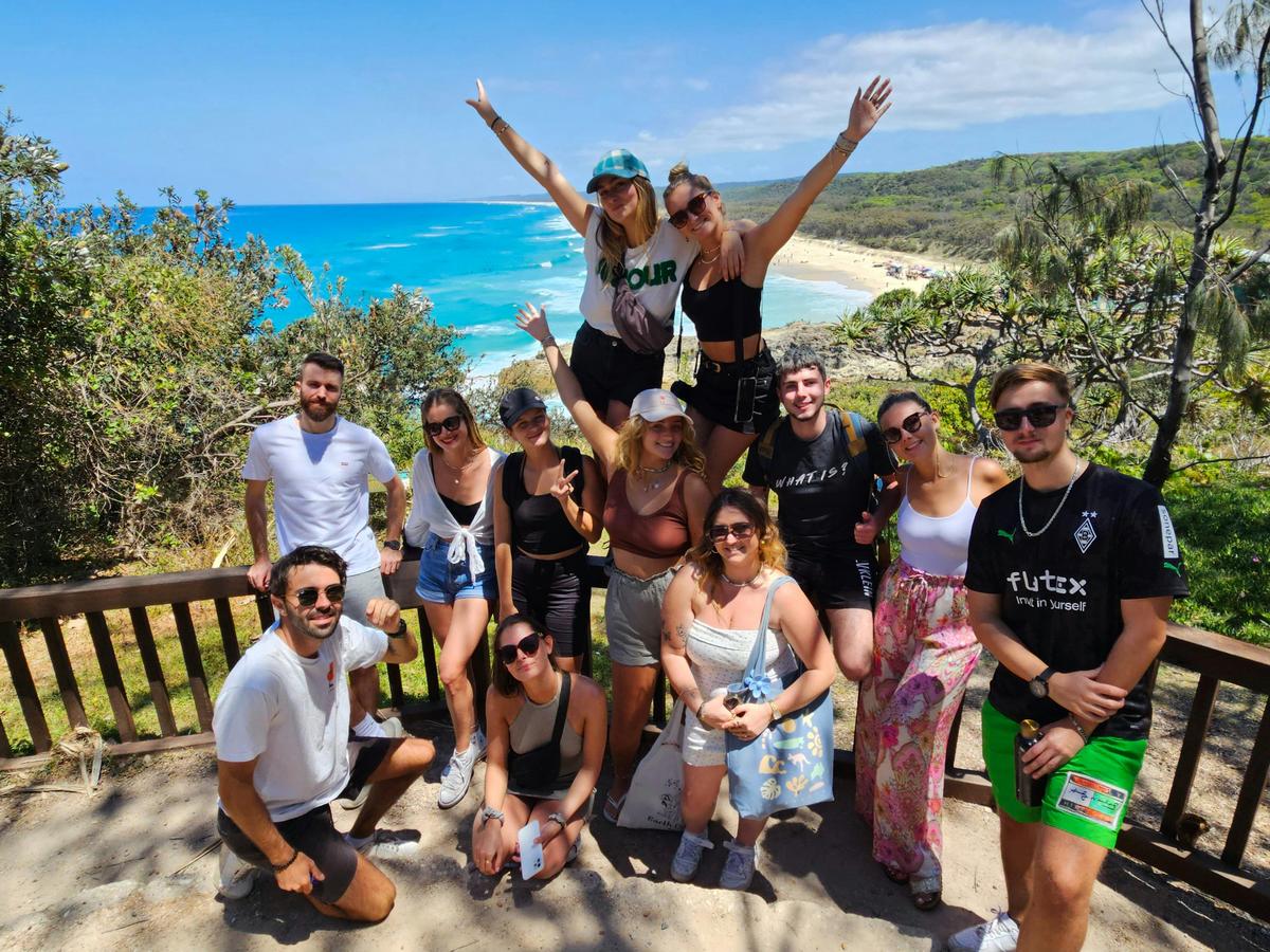Happy tour group at Point Lookout, enjoying breathtaking ocean views on a Stradbroke Island day tour