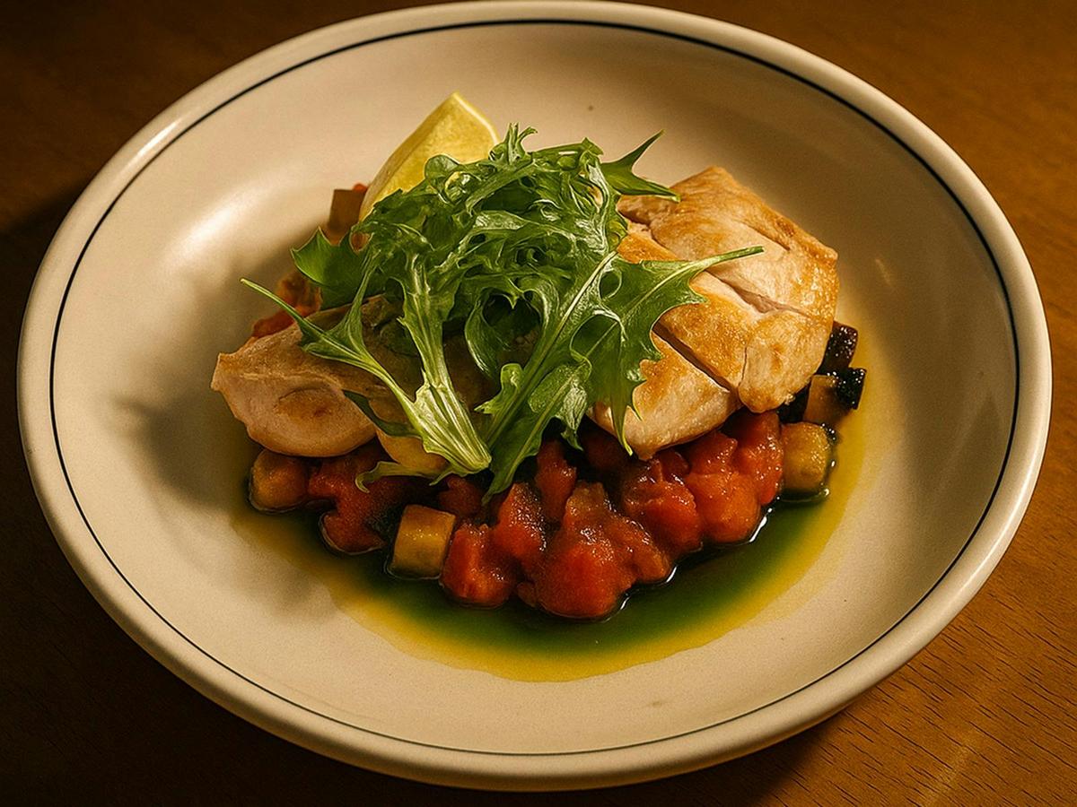 Tender chicken on a bed of tomato‑braised vegetables