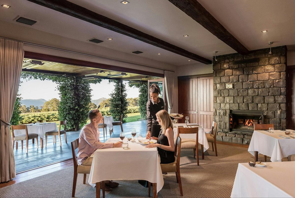 A couple dining at The Peak as a waittress serves them