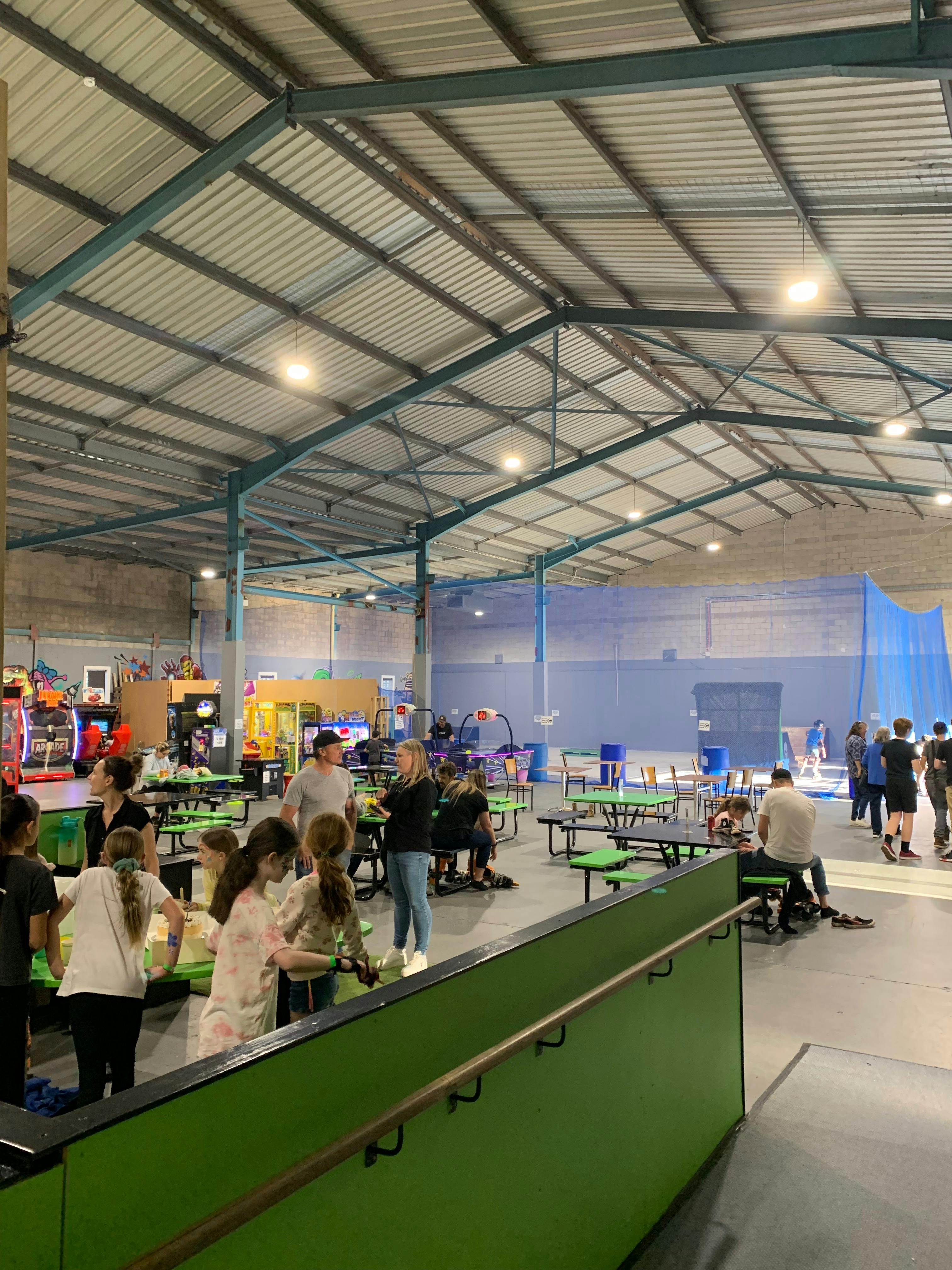 Exiting the rink, you see booths and seating, arcades and street ramp section in the background