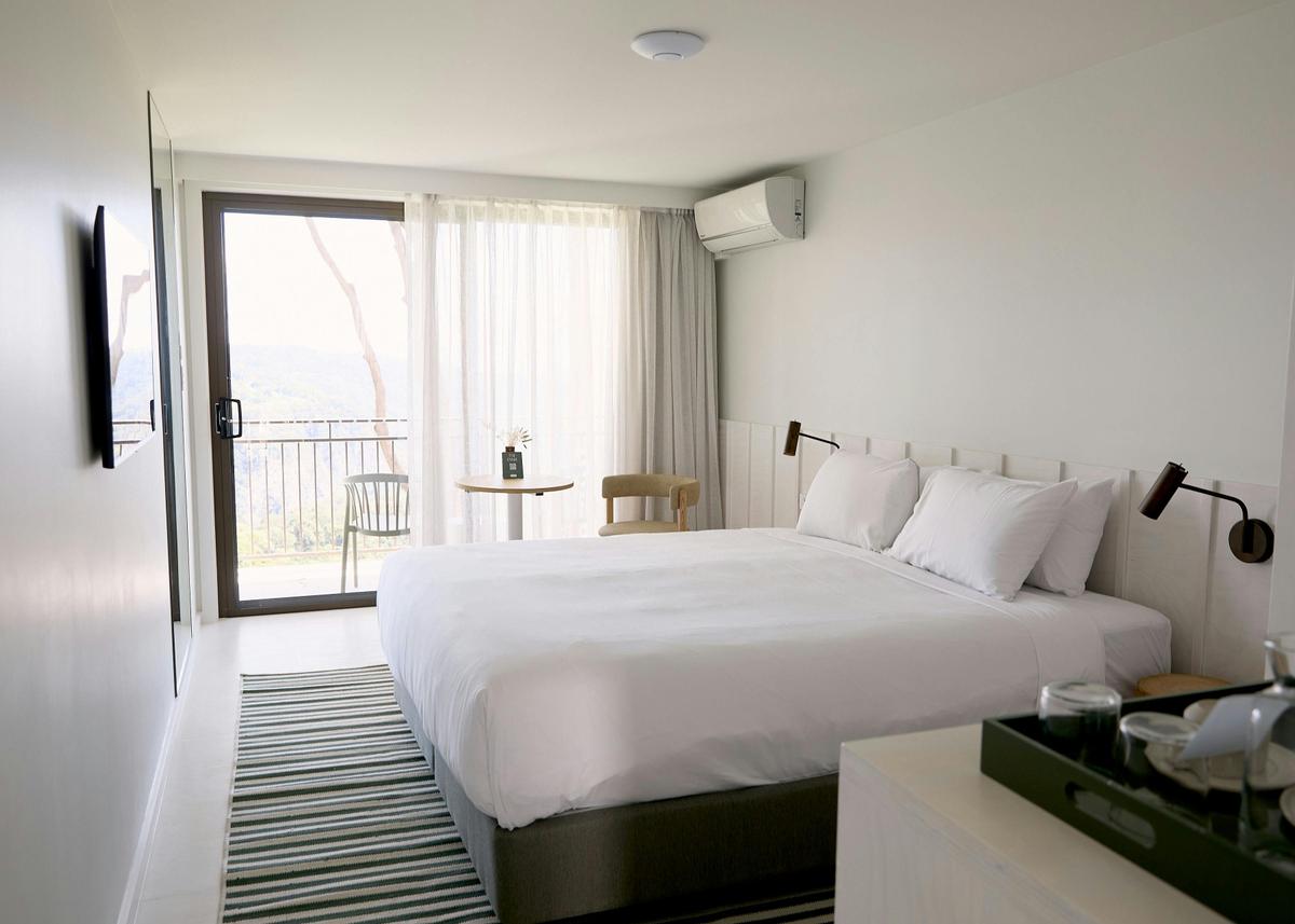 A balcony room with king size bed