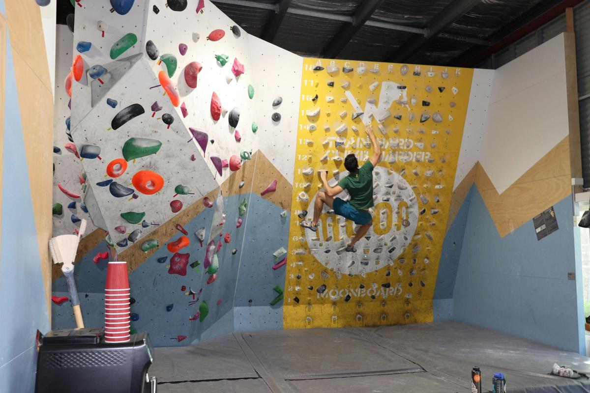A climber using the 25 degree MoonBoard at Wall Walkers Bouldering