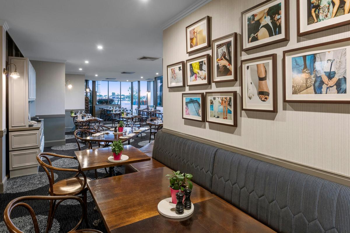 Restaurant with tables and pictures on the wall