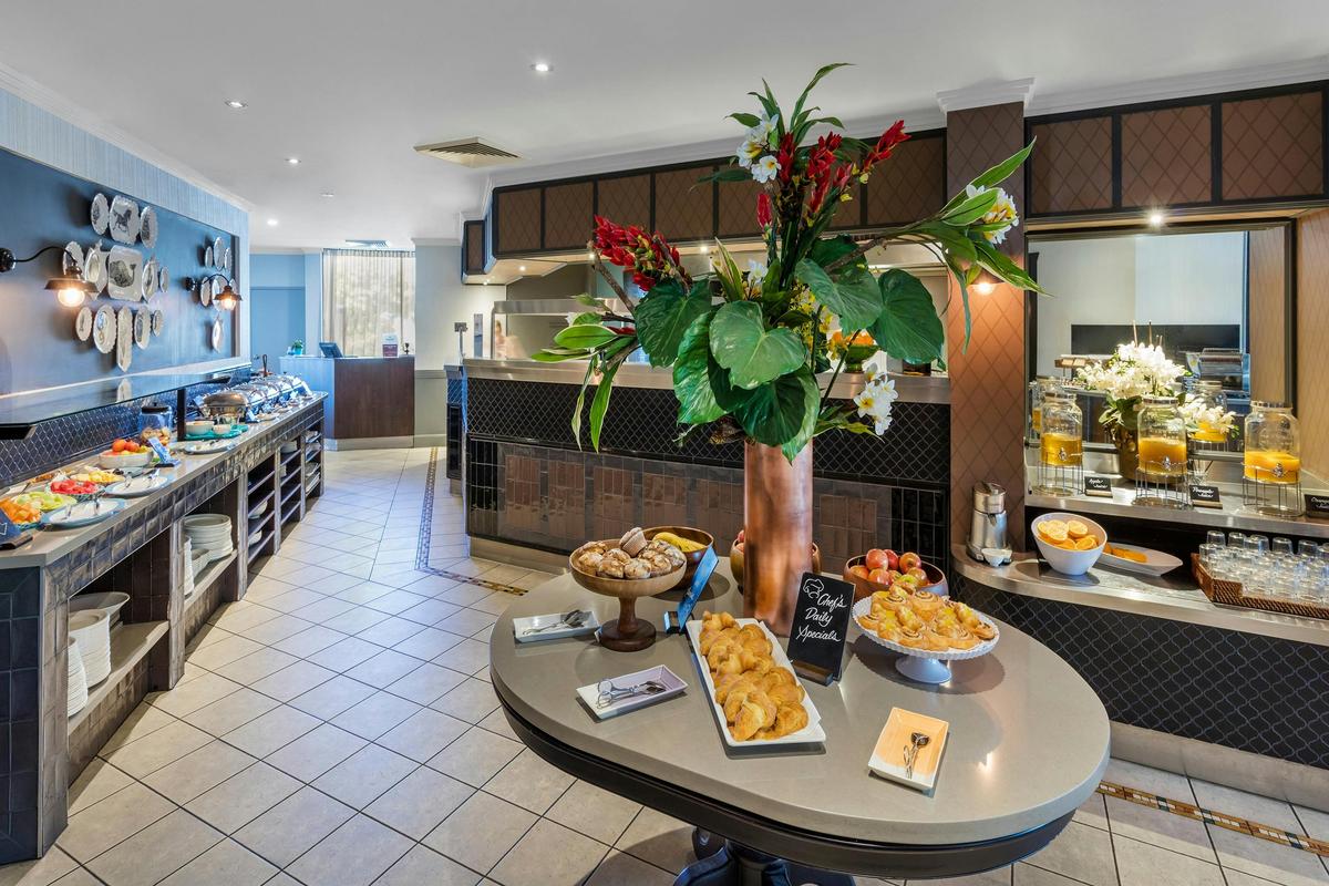 Restaurant with pastries and flowers at the entrance