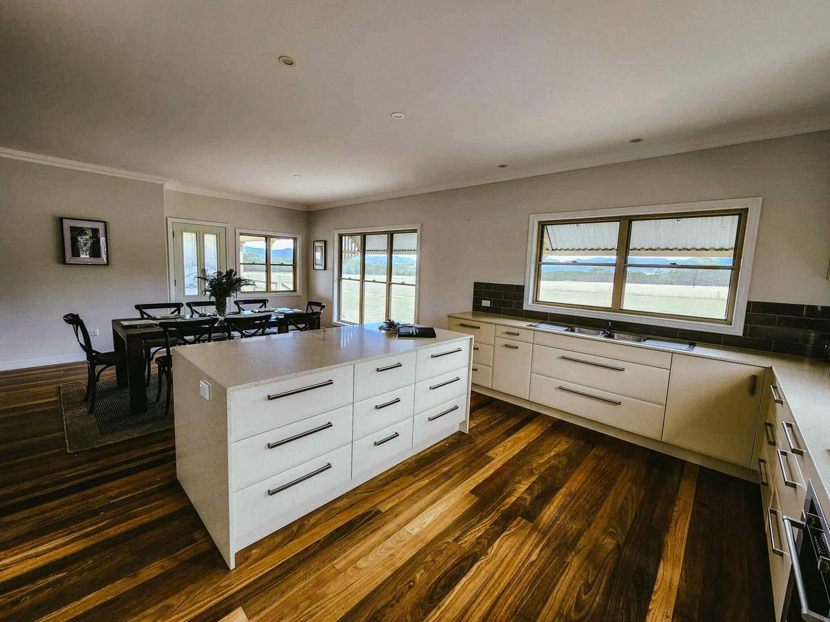 Modern kitchen with walk in pantry and dishwasher and 8 seater dining with bar stools