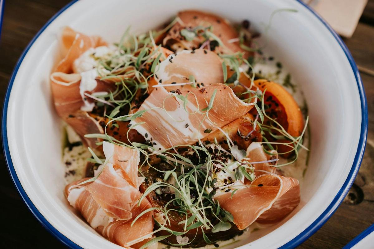 HEIRLOOM TOMATOES Stracciatella Cheese, Toasted Nigella Seeds, Prosciutto, Rocket & Black Olive Crum