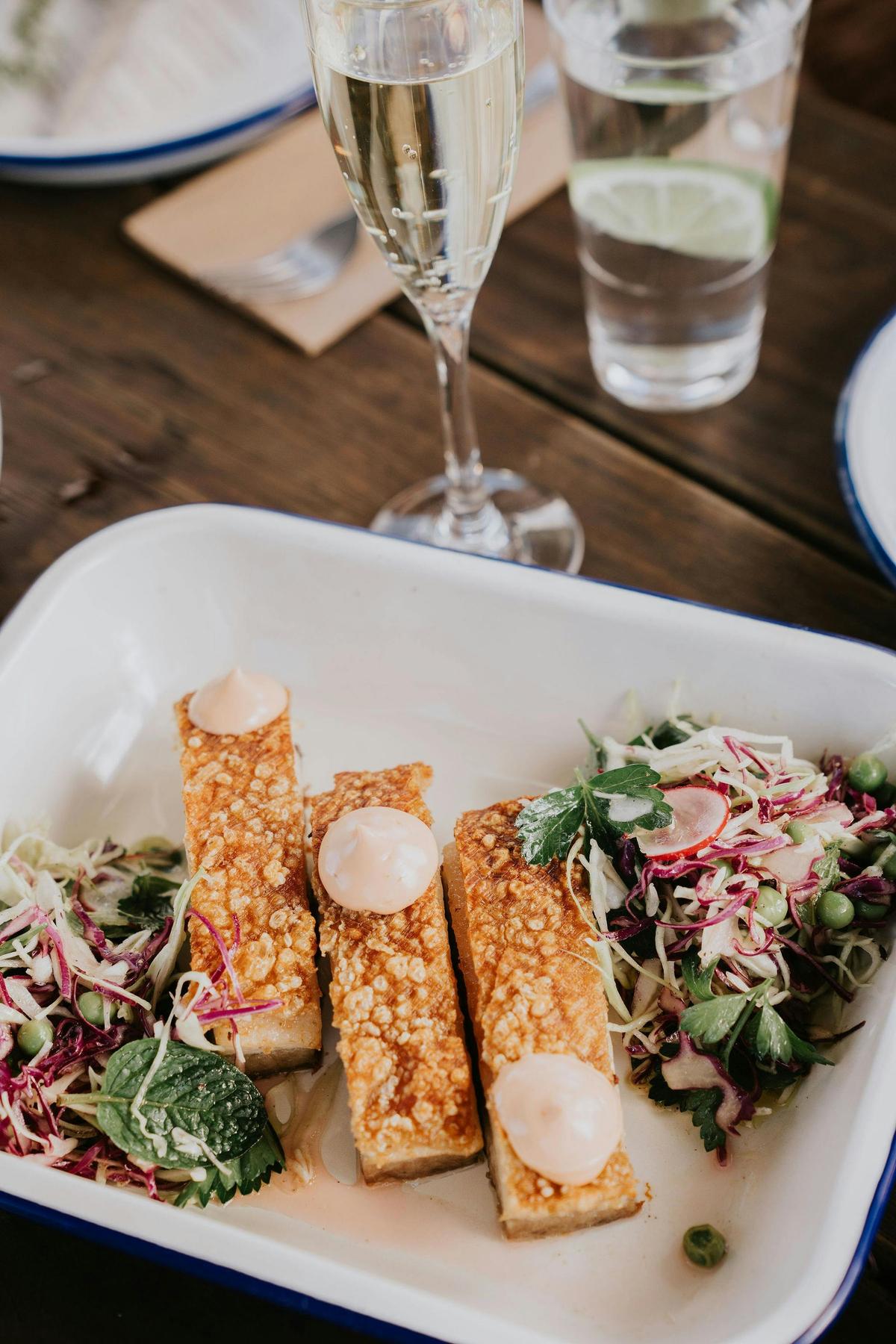 ROAST FREE RANGE PORK BELLY Fresh Radish, Peas, Mint, Cabbage Salad & Smoked Pepper Skordalia