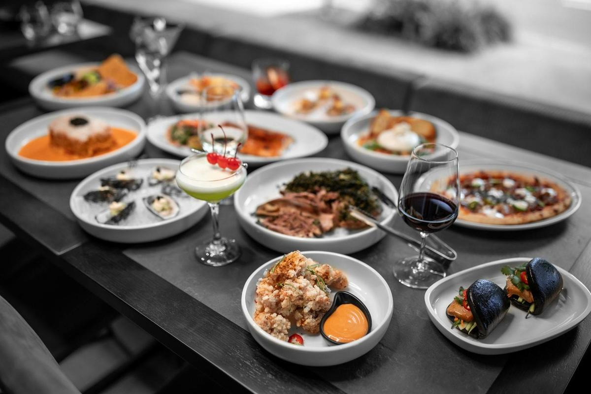 spread of food dishes and cocktails