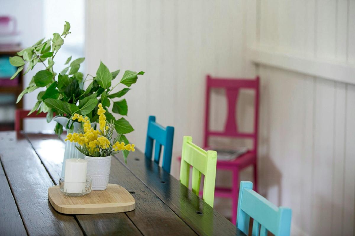 Colourful & eclectic dining room featuring a solid handmade table