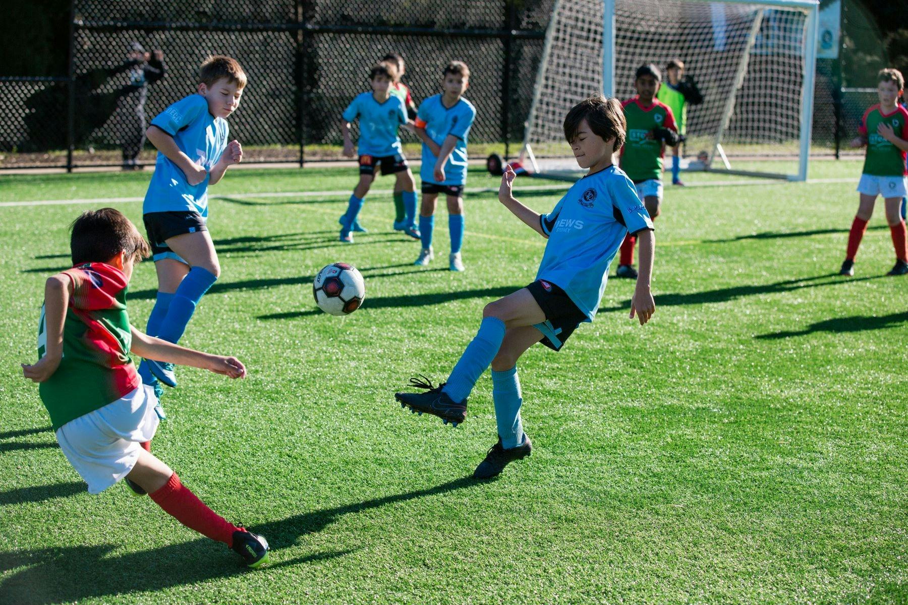Two teams of children engage in a spirited game of soccer.