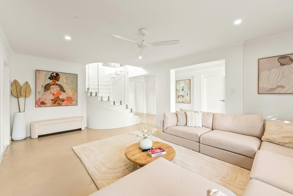 The sculptural curved staircase links the two living levels.