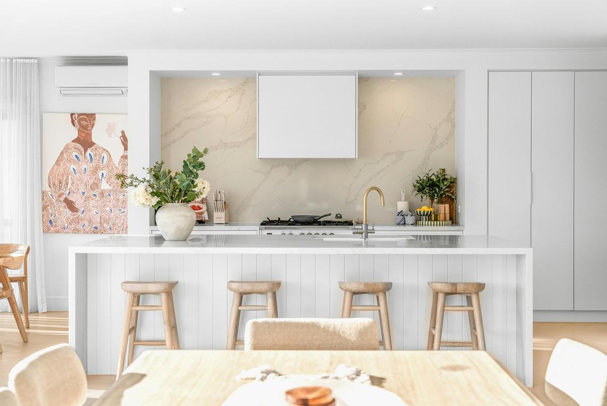 Chef's kitchen with a stone island and gas cooktop.