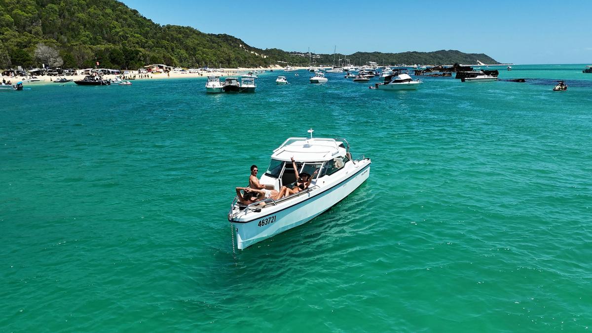Anchored in the clear shallows of Moreton Bay, the whole boat to yourselves.