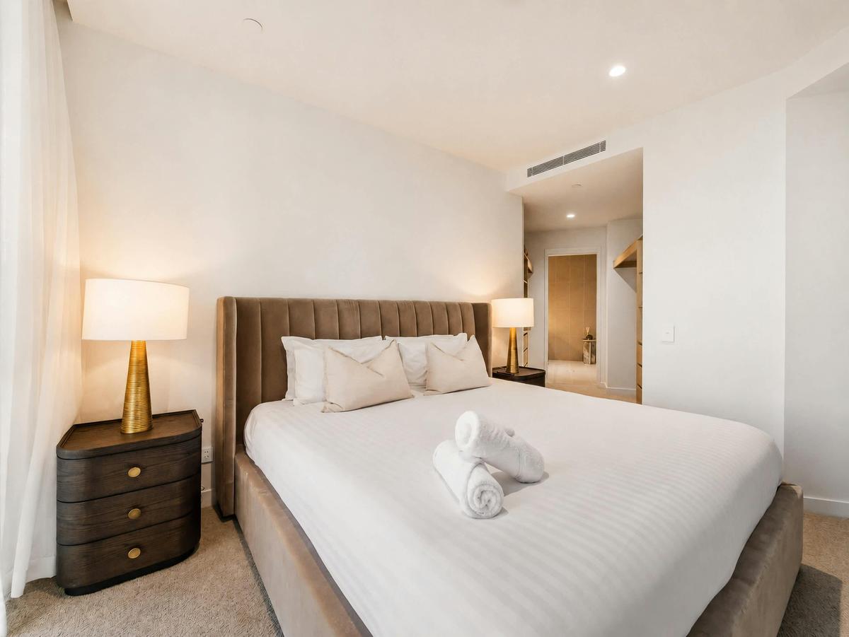 The main bedroom takes a king, with the walk in robe and ensuite beyond.