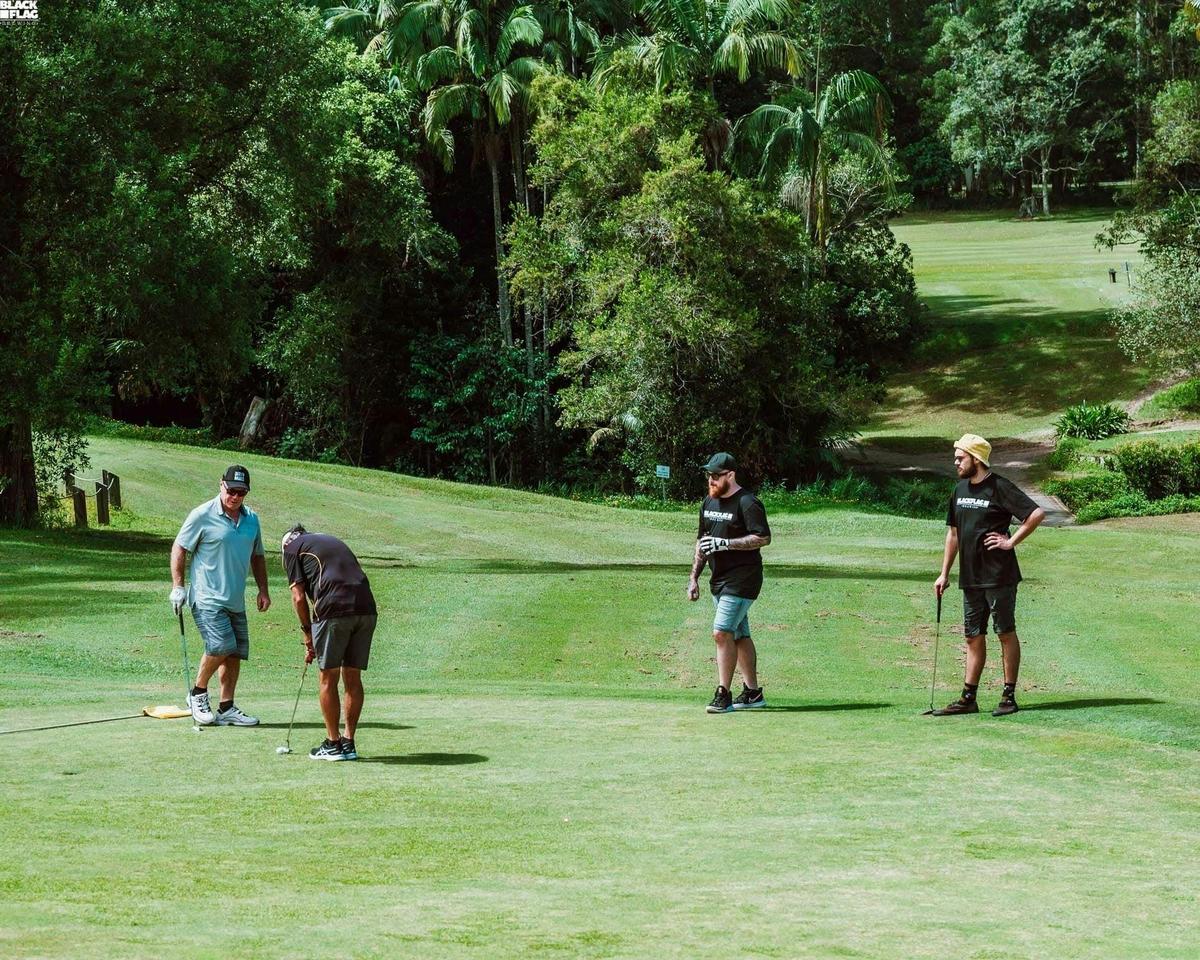 Golfers enjoying a beer and working on their short game.