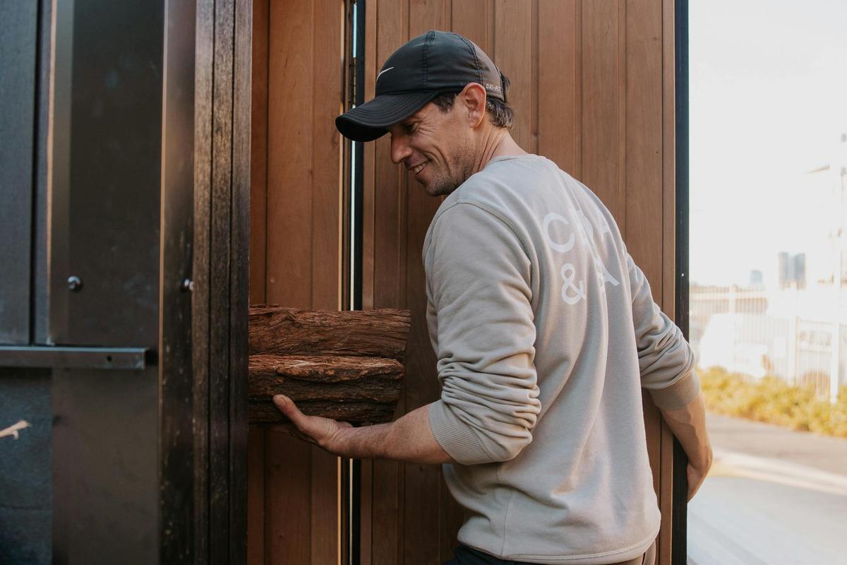 Stocking the fire - Cedar & Salt Sauna