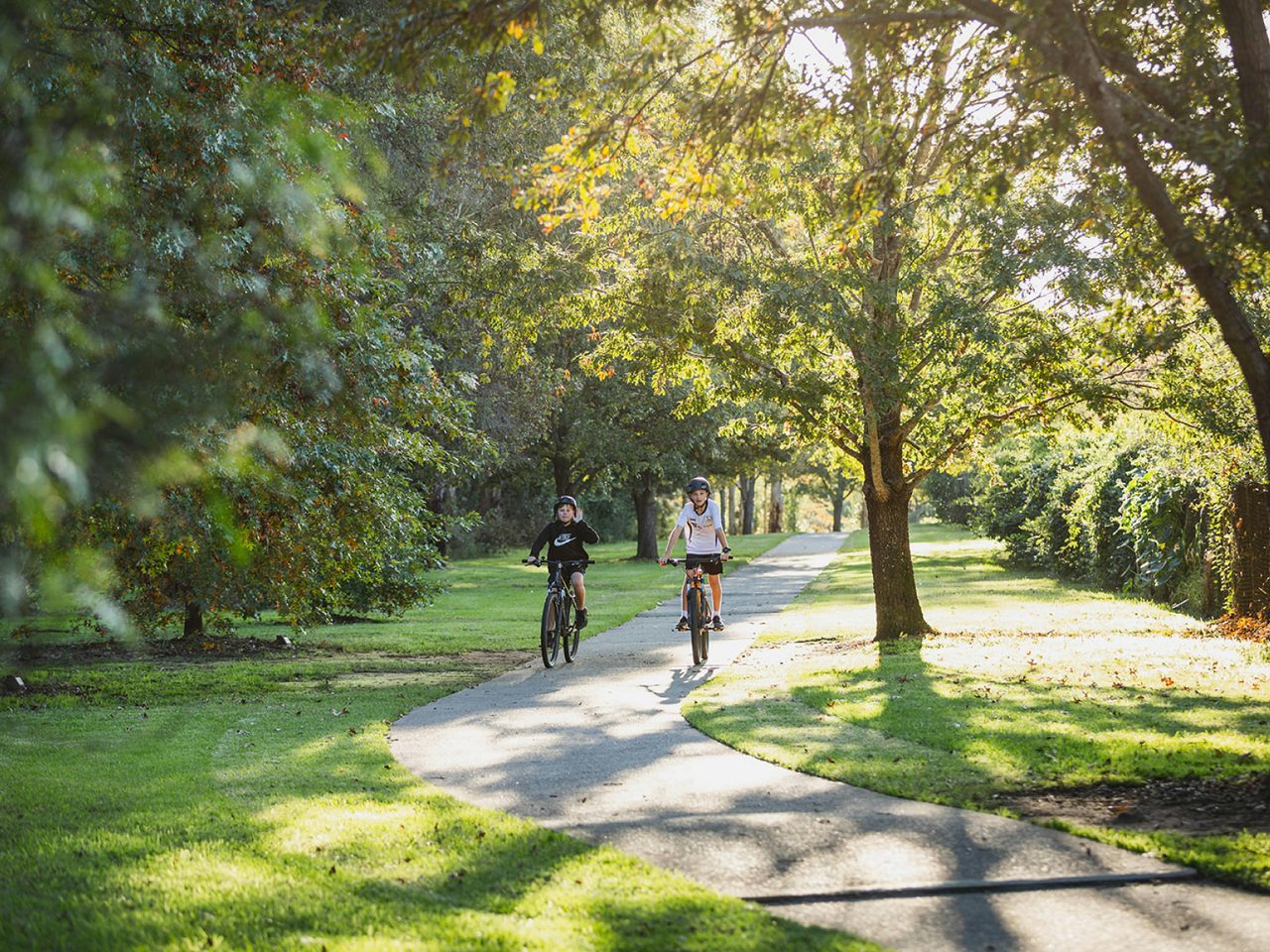 two kids riding their bikes at Picton Botanic Gardens